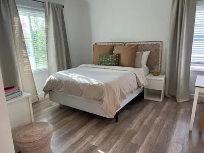 a bedroom with a bed and two windows at Charming Cozy Studio 5 Minutes from Sofi Stadium in Los Angeles