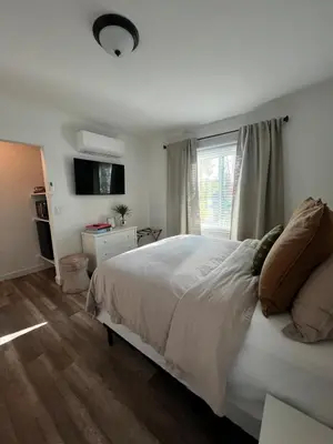 a bedroom with a white bed and a window at Charming Cozy Studio 5 Minutes from Sofi Stadium in Los Angeles