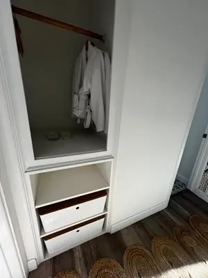 a closet with a white cabinet with a shirt in it at Charming Cozy Studio 5 Minutes from Sofi Stadium in Los Angeles