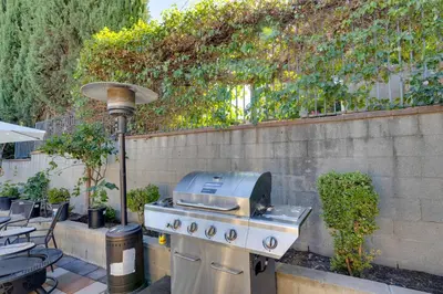 a grill sitting on a patio next to a wall at 4 Mi to Old Pasadena Walkable Studio in Alhambra