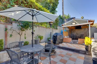 a table and chairs with an umbrella on a patio at Walk to Main St! Pet-Friendly Alhambra Studio in Alhambra