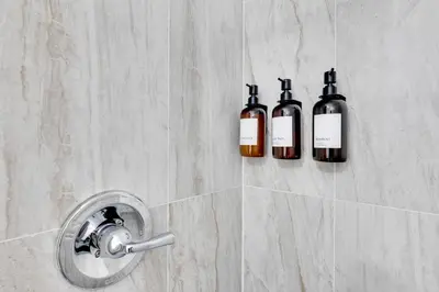 three bottles of wine on the wall of a shower at Walk to Main St! Pet-Friendly Alhambra Studio in Alhambra