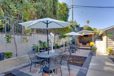 a table and chairs with an umbrella on a patio at 2 Blocks to Main St Foodies Paradise in Alhambra in Alhambra