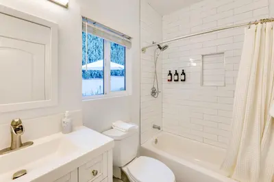 a white bathroom with a toilet and a sink at 2 Blocks to Main St Foodies Paradise in Alhambra in Alhambra