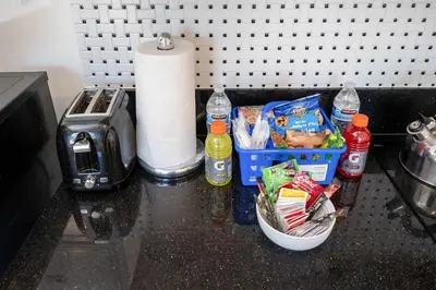 a counter with a basket of food and a roll of paper towels at Remodeled Chick Studio Near Downtown LA, AC, WiFI, WD, Snack in Los Angeles