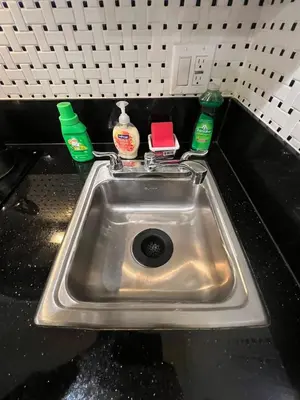 a sink in a kitchen with two soap bottles at Remodeled Chick Studio Near Downtown LA, AC, WiFI, WD, Snack in Los Angeles