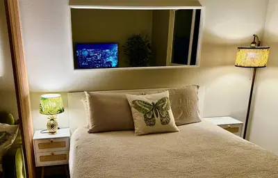 a bedroom with a bed with a butterfly pillow on it at Stylish Studio in Mid-Wilshire with Pool, Free Parking, Gym in Prime Location in Los Angeles