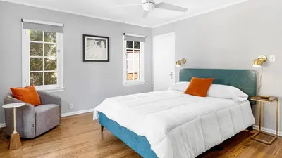 a bedroom with a bed and a chair at Cozy Hollywood Hideaway w Private Patio Easy City Access Casa Camrose by AvantStay in Los Angeles