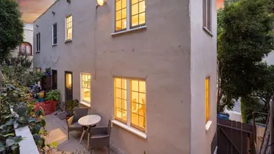 an exterior view of a house with a table and windows at Cozy Hollywood Hideaway w Private Patio Easy City Access Casa Camrose by AvantStay in Los Angeles
