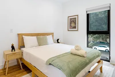 a bedroom with a large bed and a window at Platinum Suite LA in Los Angeles