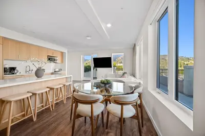 a kitchen and dining room with a table and chairs at The Jade Hill Views - Penthouse - Pool, Gym, Balcony in Los Angeles