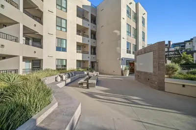 a building with benches in front of a building at The Jade Hill Views - Penthouse - Pool, Gym, Balcony in Los Angeles