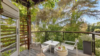 a patio with a table and chairs on a deck at Spanish Revival Charm in Silver Lake w Patio BBQ Walkable Location Maltman Manor by AvantStay in Los Angeles