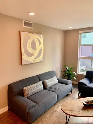 a living room with a couch and a table at Contemporary 2BR Prime Hollywood Location in Los Angeles