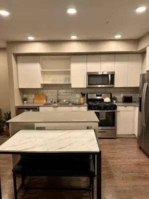 a kitchen with white cabinets and stainless steel appliances at Contemporary 2BR Prime Hollywood Location in Los Angeles