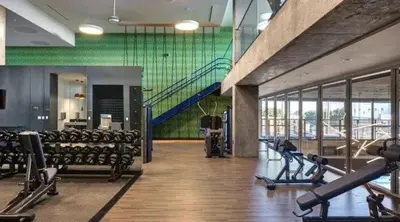 a gym with rows of treadmills and chairs in a building at Contemporary 2BR Prime Hollywood Location in Los Angeles