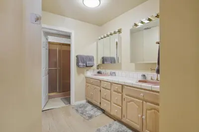 a bathroom with two sinks and a large mirror at Spacious Mountain Getaway Game Room & Gazebo villa in Pine Mountain Club