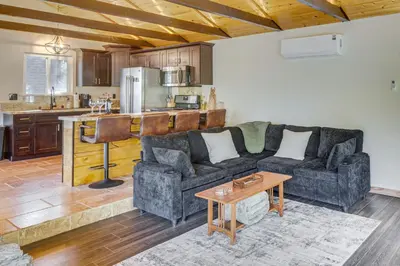 a living room with a couch and a table at Walk to Village! Romantic Pine Mtn Nature Escape in Pine Mountain Club