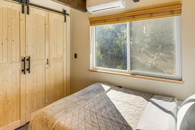 a bedroom with a bed and a window at Walk to Village! Romantic Pine Mtn Nature Escape in Pine Mountain Club