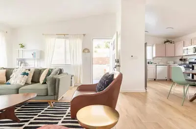 a living room with a couch and a table at Huth Street Haven in Lake Isabella