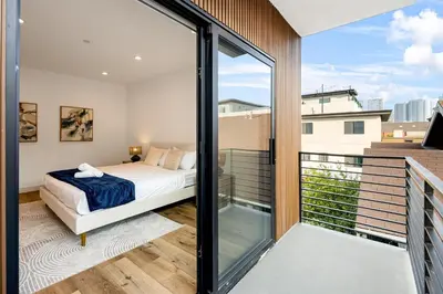 a bedroom with a bed and a balcony at Metro Loft LA in Los Angeles