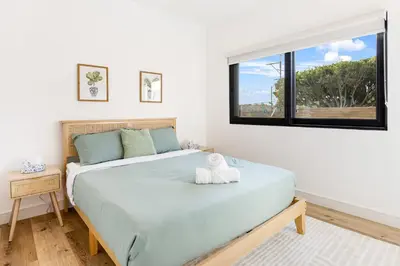 a bedroom with a large bed with a window at Metro Loft LA in Los Angeles