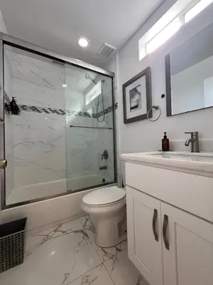 a bathroom with a shower and a toilet and a sink at Serene Luxe Residence near Rose Bowl in Pasadena