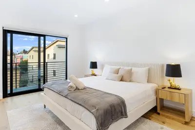 a bedroom with a large bed and a large window at Sky Haus LA in Los Angeles