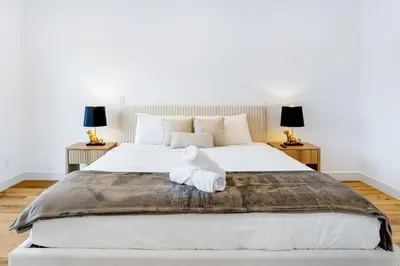 a bedroom with a large white bed with two lamps at Sky Haus LA in Los Angeles