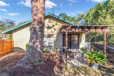 a house with a tree in front of it at Pet friendly 3BR Spacious Home EV in Riverside