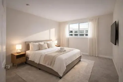 a white bedroom with a bed and a window at Marina Del Rey Apartment with Resort Amenities - Short Distance To Venice Beach in Los Angeles