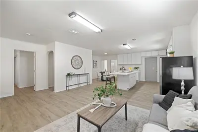 a living room with a couch and a table and a kitchen at 4 bedrooms in Long Beach