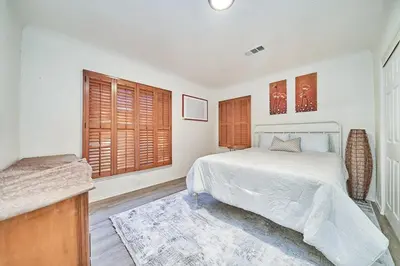 a bedroom with a bed and a large window at 4 bedrooms in Long Beach