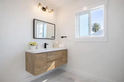 a bathroom with a sink and a window at Modern 3BR Home Near USC, Museums & Coliseum in Los Angeles