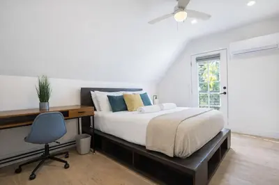 a bedroom with a bed and a desk and a chair at Modern 3BR Home Near USC, Museums & Coliseum in Los Angeles