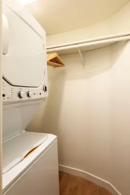 a small kitchen with a white refrigerator at Beverly Grove Hotel in Los Angeles