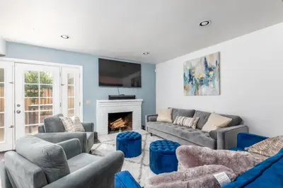 a living room with couches and a fireplace at Heidi House Entire Duplex Relocation Stays in Redlands
