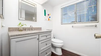 a white bathroom with a sink and a toilet at Heidi House Entire Duplex Relocation Stays in Redlands
