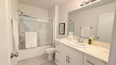 a bathroom with a sink and a toilet and a mirror at Modern Luxury House 3B&4B House 30 mins DTLA in Baldwin Park