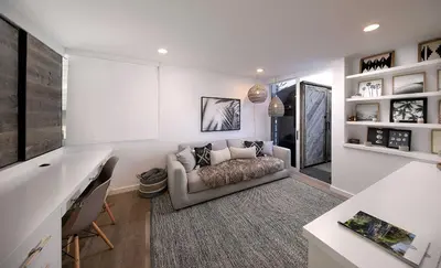 a living room with a couch and a desk at Rincon Refuge - Beachfront for 6 in Ventura