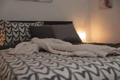 a white blanket laying on top of a bed at Pet-Friendly 2BR-2BA Near SoFi-Small Dogs Welcome in Los Angeles