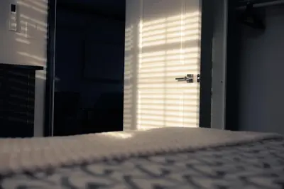 a bedroom with a bed and a door with a window at Pet-Friendly 2BR-2BA Near SoFi-Small Dogs Welcome in Los Angeles