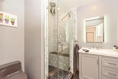 a bathroom with a shower and a toilet and a sink at The SOFI Special - Modern Retreat, Dog Friendly in Los Angeles