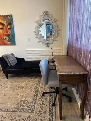 a living room with a couch and a table and a mirror at San Pedro Delight in San Pedro Peninsula Hospital Heliport