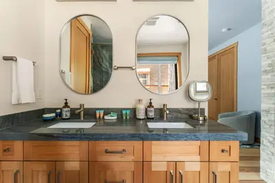 a bathroom with two sinks and two mirrors at 34 - The Maple Crest home in Big Bear Lake