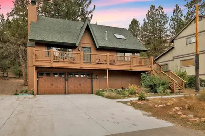 a large house with a deck and a garage at Lakeview Pines Log Cabin #2585 in Big Bear Lake