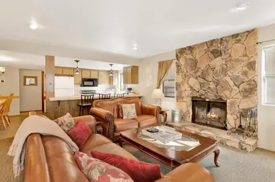 a living room with a couch and a fireplace at Summit Ski and Bike Trails #2574 in Big Bear Lake