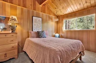 a bedroom with a bed and a dresser and a window at Slope Side Getaway #2526 in Big Bear Lake