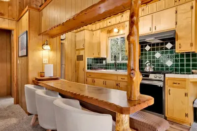 a kitchen with a long wooden table and chairs at Slope Side Getaway #2526 in Big Bear Lake