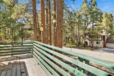 a green fence in front of a house at Slope Side Getaway #2526 in Big Bear Lake
